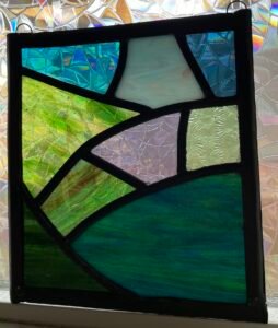 While visiting my stained glass friend in Scotland, she taught me the lead came method she uses and we had a blast selecting glass that would represent the landscape of Aberdeenshire. While it hangs 4,500 miles from its source, it warms my heart every time I look at it.